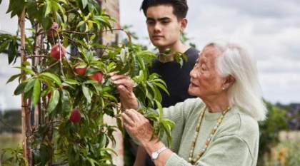 Anne, 92, tending to her garden with a younger relative