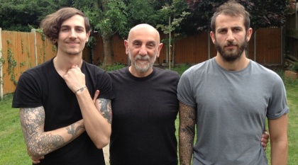 Armen stands next to his two sons, Robert and Greg.